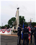 Service members standing with flags