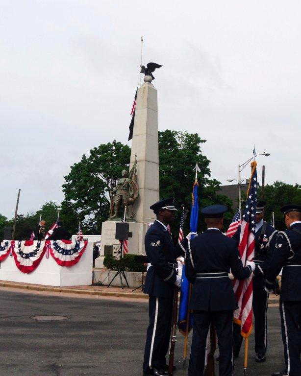 Service members standing with flags
