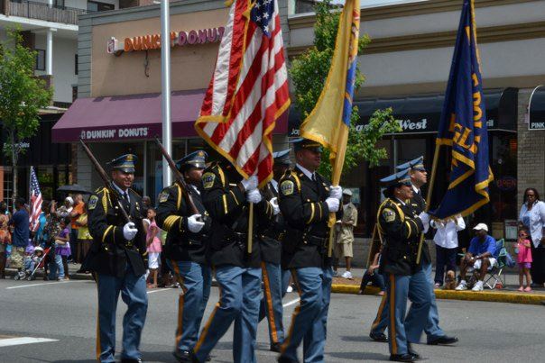Service members walking with flags