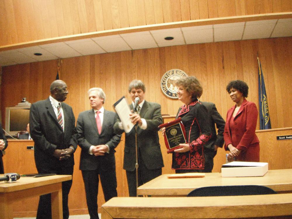 Council members standing at a meeting